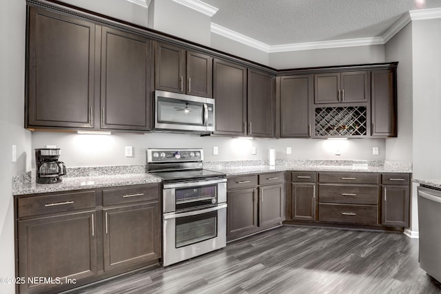 kitchen with stainless steel appliances, dark hardwood / wood-style flooring, crown molding, a textured ceiling, and dark brown cabinets