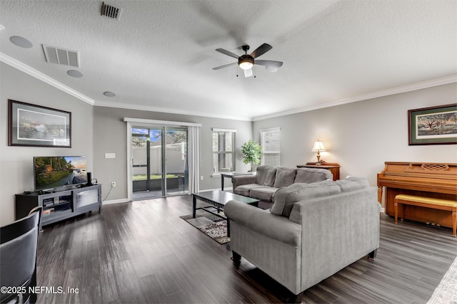 living room featuring ceiling fan, dark hardwood / wood-style floors, crown molding, and a textured ceiling