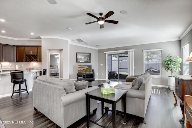 living room with a textured ceiling, vaulted ceiling, ceiling fan, crown molding, and dark hardwood / wood-style floors