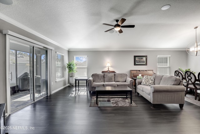 living room with a textured ceiling, dark hardwood / wood-style floors, ceiling fan, and crown molding