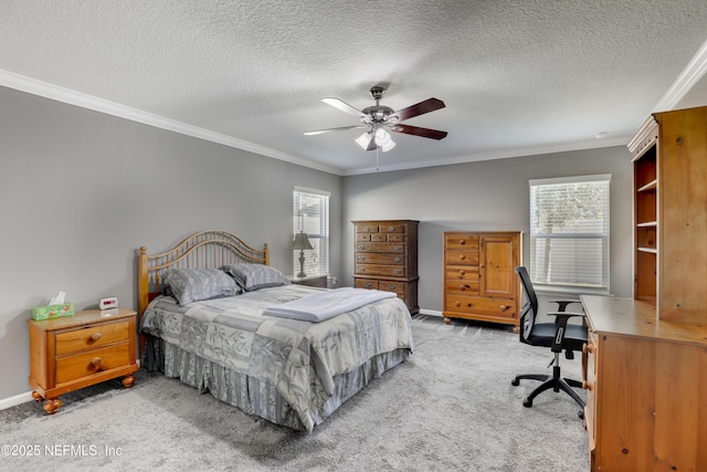 bedroom with ceiling fan, crown molding, light colored carpet, and a textured ceiling