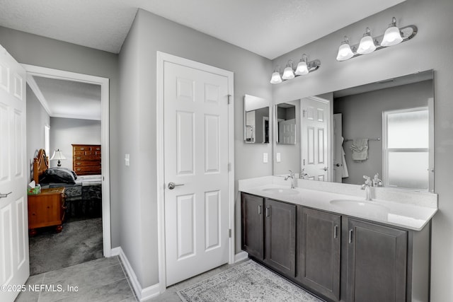 bathroom featuring plenty of natural light, vanity, a textured ceiling, and tile patterned flooring