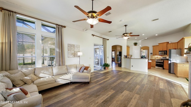 living room featuring light hardwood / wood-style floors, a wealth of natural light, ornamental molding, and ceiling fan