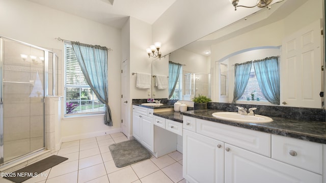 bathroom featuring vanity, tile patterned floors, and a shower with shower door