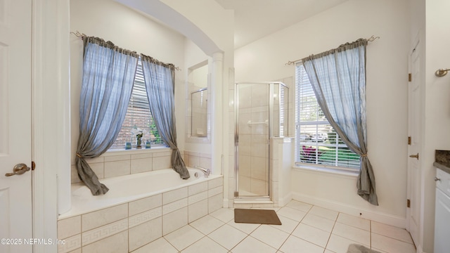 bathroom with tile patterned floors, vanity, a healthy amount of sunlight, and shower with separate bathtub