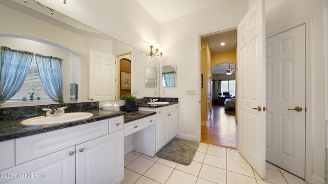 bathroom with tile patterned flooring, vanity, and ceiling fan