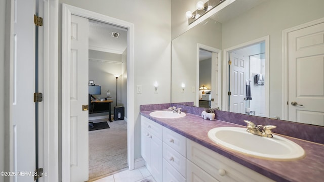 bathroom featuring tile patterned flooring, vanity, and ornamental molding