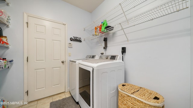 washroom with independent washer and dryer and light tile patterned flooring