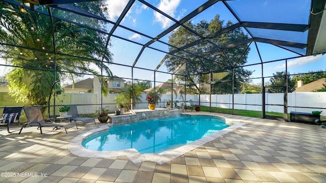 view of pool with a lanai and a patio