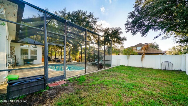 view of swimming pool with glass enclosure and a yard