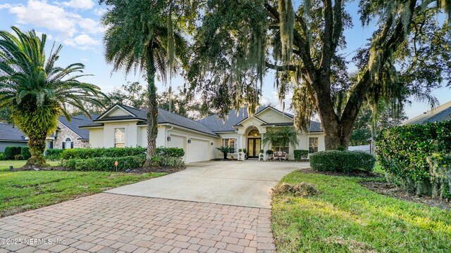 view of front of property featuring a garage and a front yard