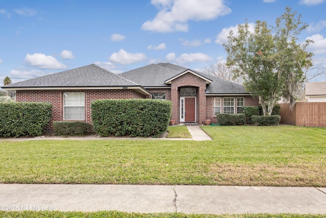 single story home featuring a front lawn