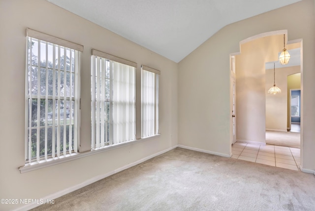 unfurnished room with carpet and lofted ceiling