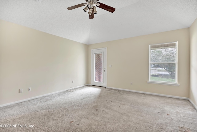 unfurnished room with ceiling fan, light colored carpet, lofted ceiling, and a textured ceiling