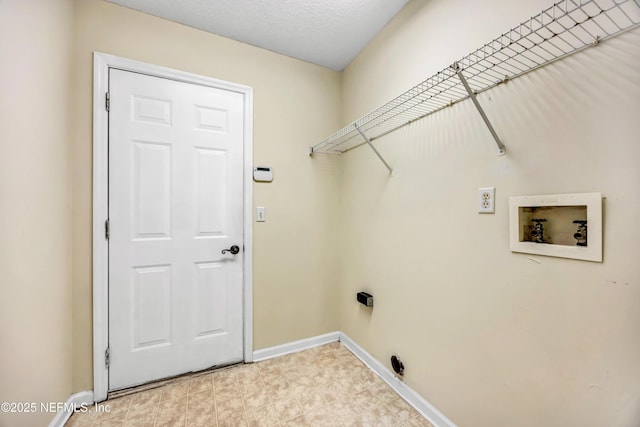 laundry room featuring hookup for a washing machine and a textured ceiling