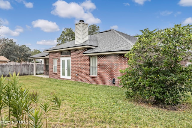 rear view of property featuring a yard and french doors