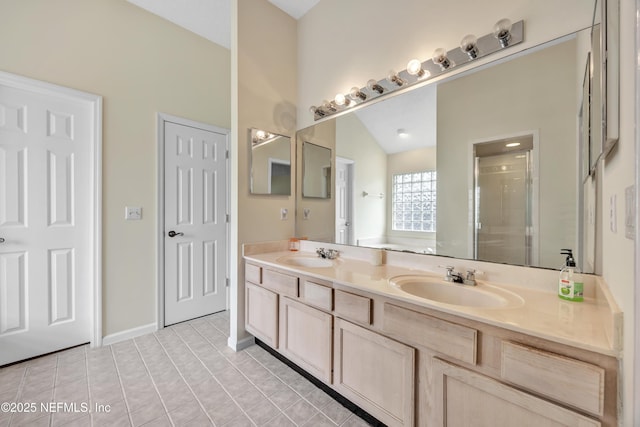 bathroom featuring tile patterned flooring, vanity, walk in shower, and vaulted ceiling