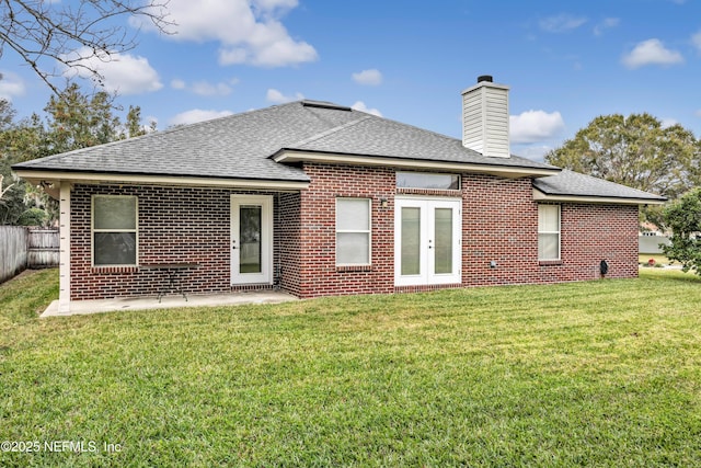 rear view of house featuring a lawn and french doors