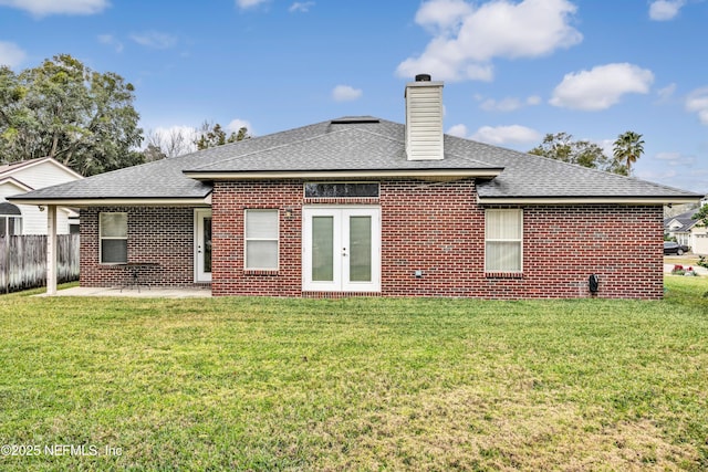 back of house with a yard, a patio area, and french doors