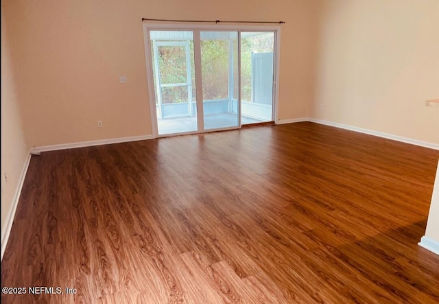 empty room with hardwood / wood-style floors