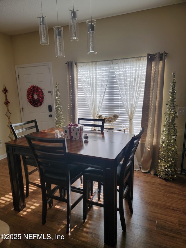 dining area featuring dark hardwood / wood-style floors