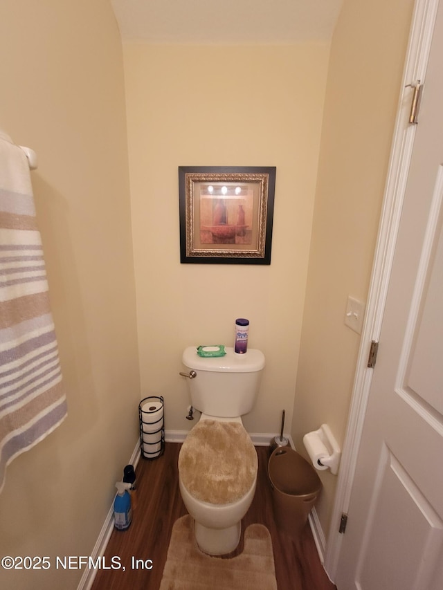 bathroom with hardwood / wood-style flooring and toilet