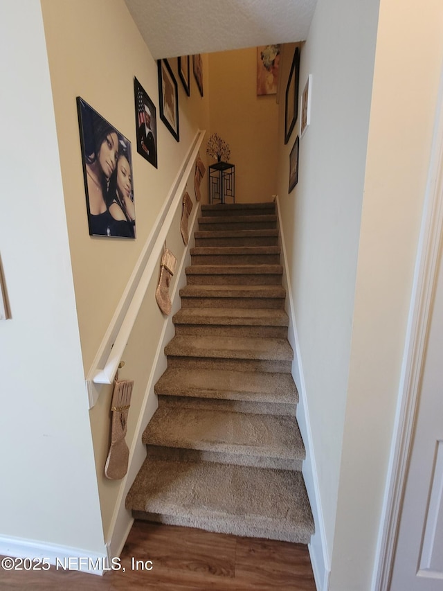 stairway with hardwood / wood-style flooring