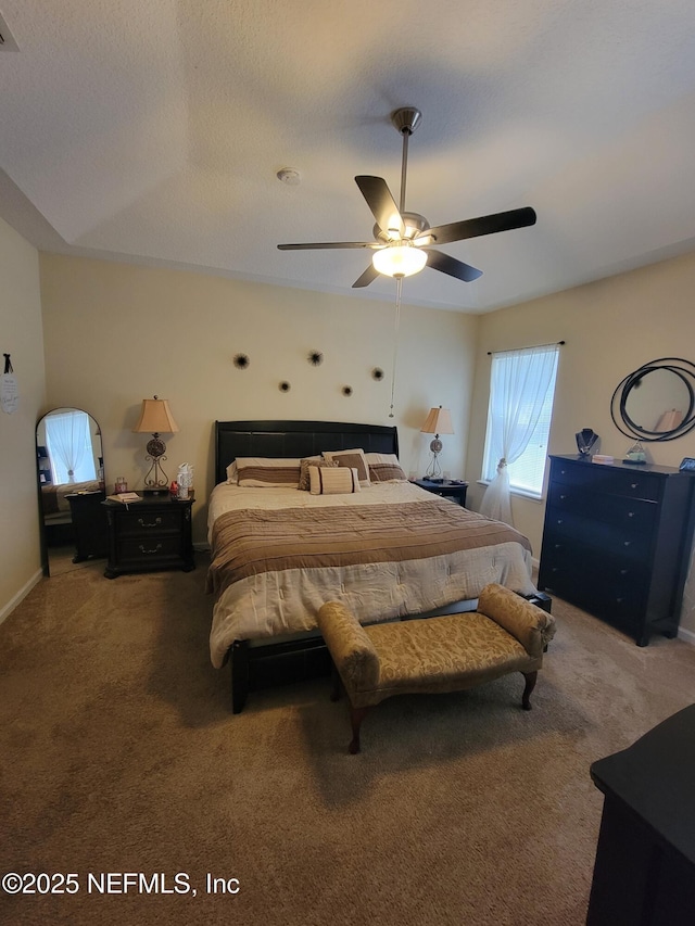 bedroom with carpet flooring, a textured ceiling, and ceiling fan