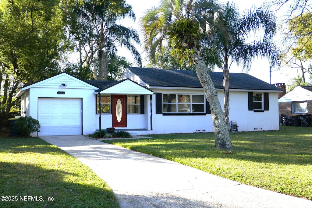 single story home with a garage and a front lawn