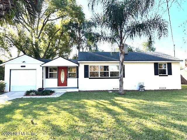 ranch-style home with a front yard and a garage