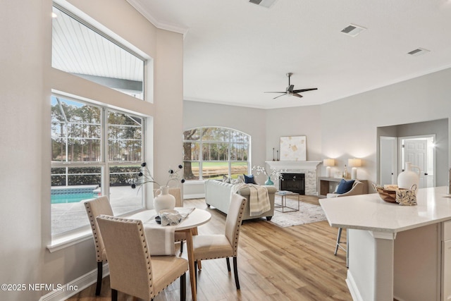 dining area with ceiling fan, plenty of natural light, and light hardwood / wood-style flooring