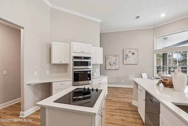 kitchen featuring stainless steel double oven, dishwasher, a kitchen island, white cabinetry, and black electric stovetop