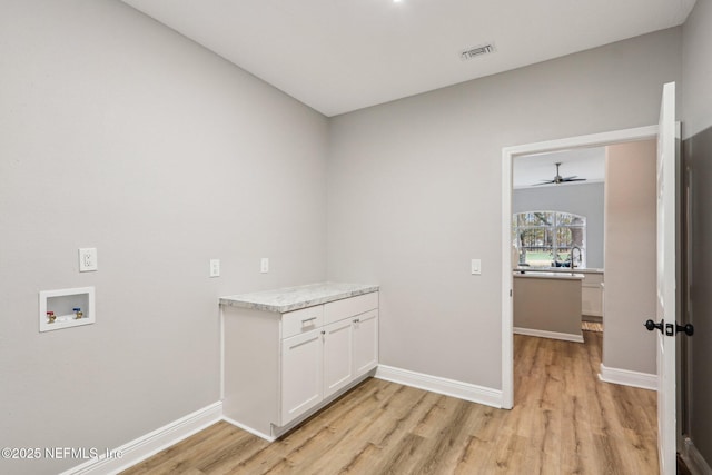 laundry area featuring cabinets, light hardwood / wood-style floors, sink, hookup for a washing machine, and ceiling fan