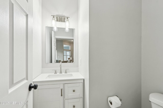 bathroom with toilet and vanity