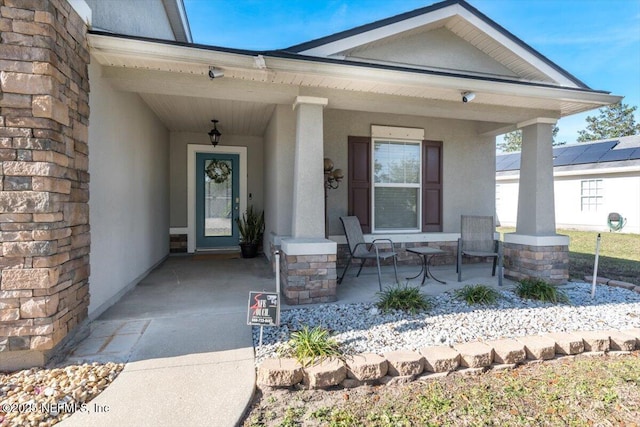 view of exterior entry featuring a porch