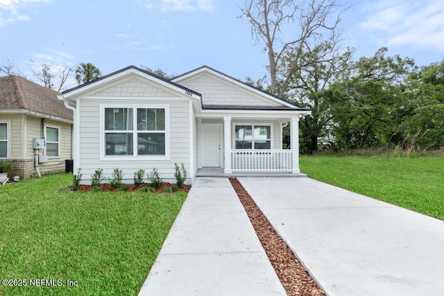 view of front of home with a porch and a front yard