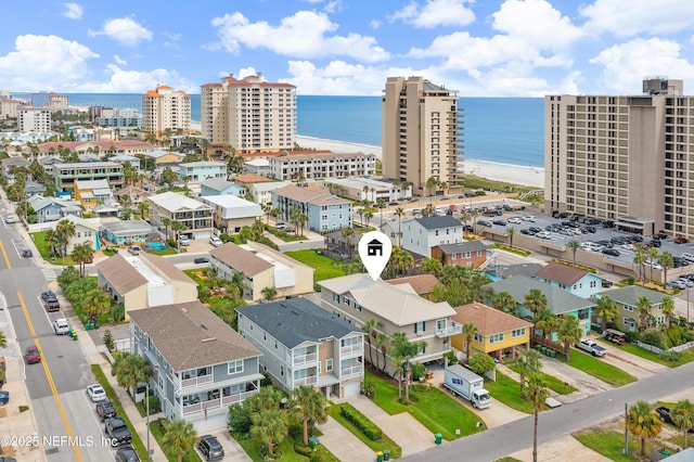 bird's eye view featuring a water view and a view of the beach