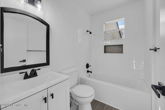 full bathroom with tiled shower / bath combo, toilet, and vanity