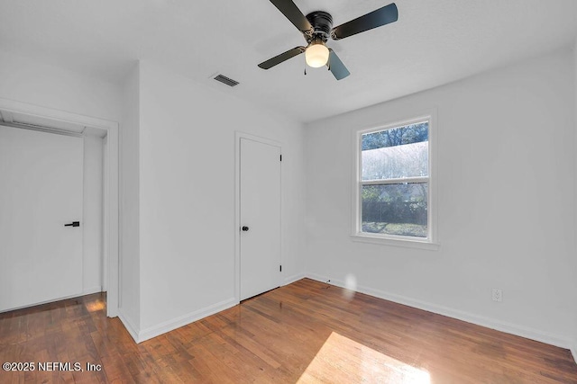 unfurnished bedroom featuring ceiling fan and hardwood / wood-style flooring