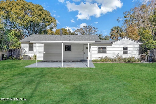 rear view of house featuring a patio area, a yard, and central AC unit