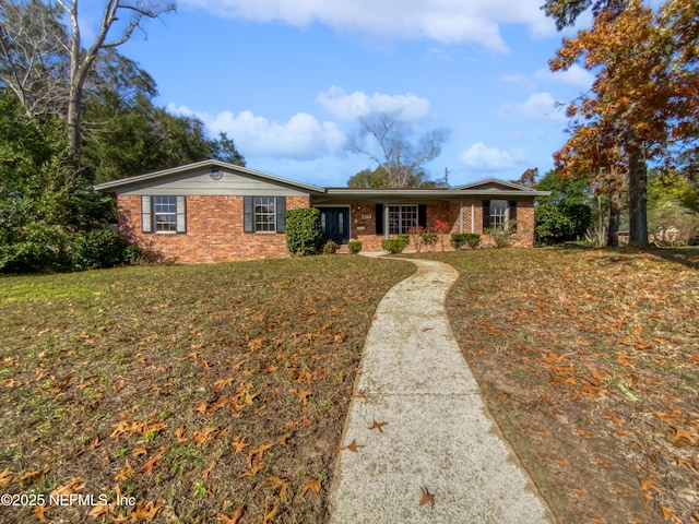 ranch-style home with a front lawn