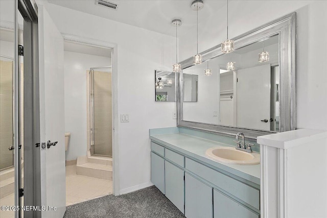 bathroom with tile patterned floors, vanity, and an enclosed shower