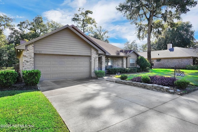 single story home featuring a garage and a front lawn