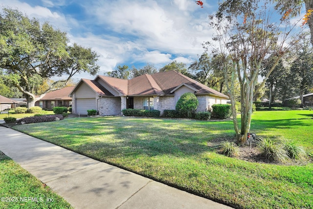 ranch-style home featuring a front yard and a garage