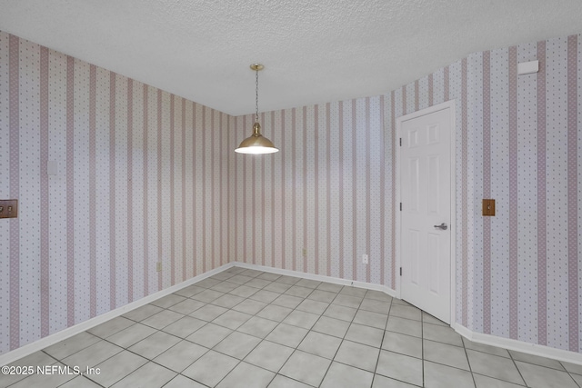 unfurnished dining area with light tile patterned floors and a textured ceiling