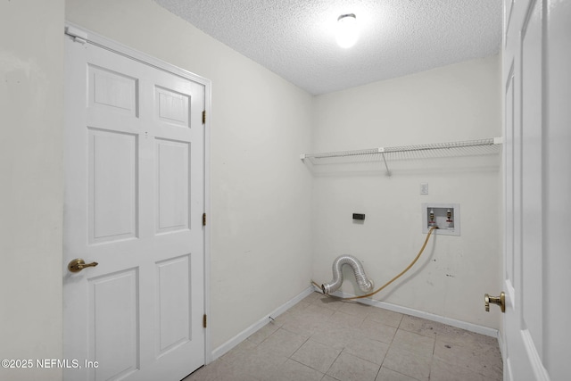 laundry room featuring washer hookup and a textured ceiling