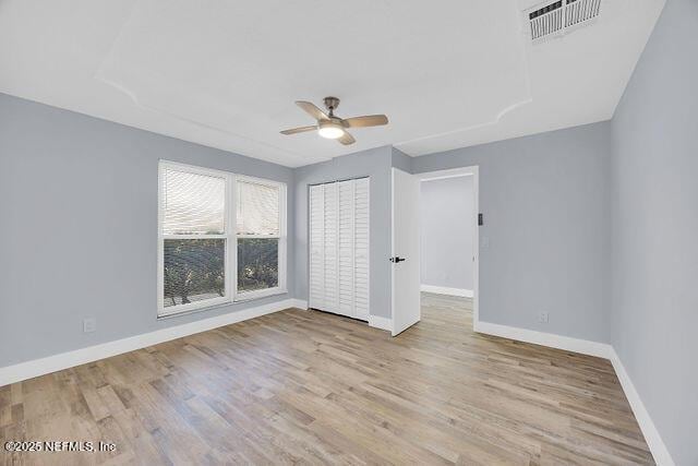 spare room with ceiling fan and light hardwood / wood-style floors