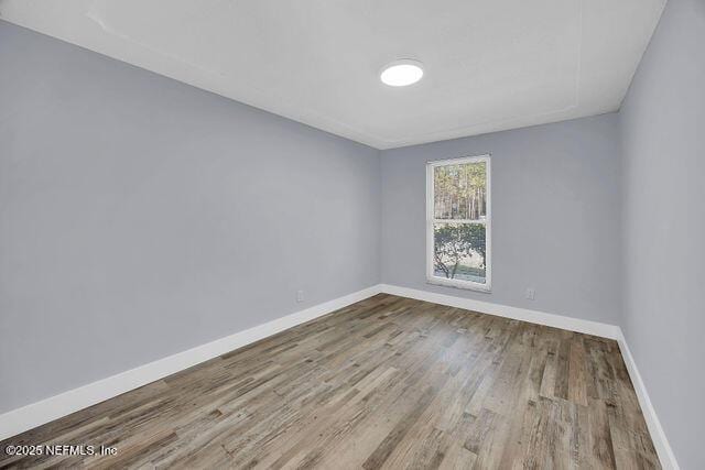 unfurnished room with light hardwood / wood-style floors