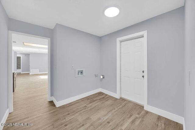 laundry room with washer hookup and light hardwood / wood-style flooring