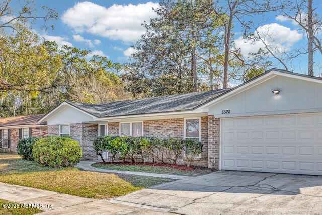 single story home featuring a garage